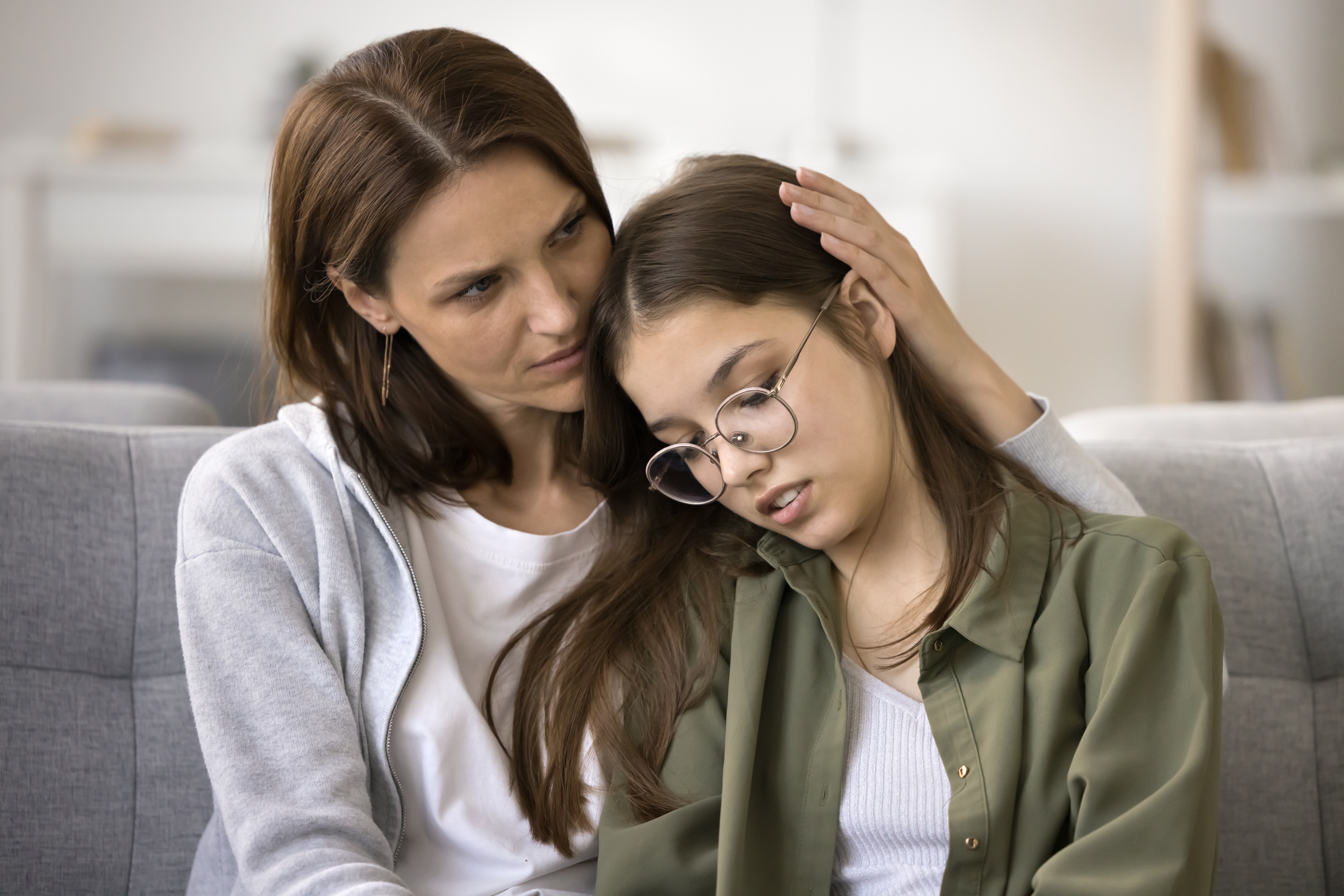 mother hugging teen daughter