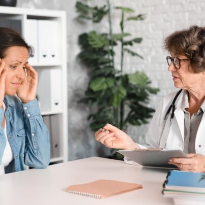 middle aged woman talking to doctor
