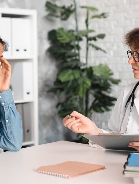 middle aged woman talking to doctor