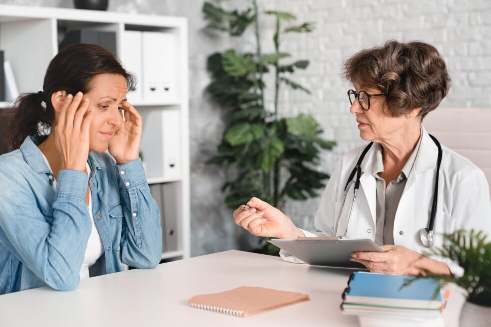 middle aged woman talking to doctor