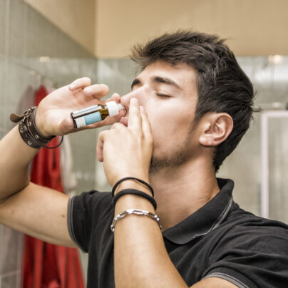 man using nasal spray