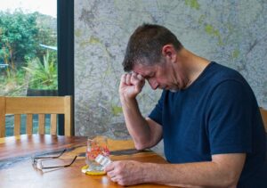 man in pain taking pain med