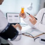 doctor talking to patient with blood pressure cuff