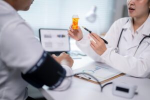 doctor talking to patient with blood pressure cuff