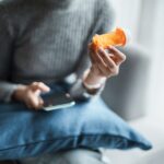 woman looking at pill bottle