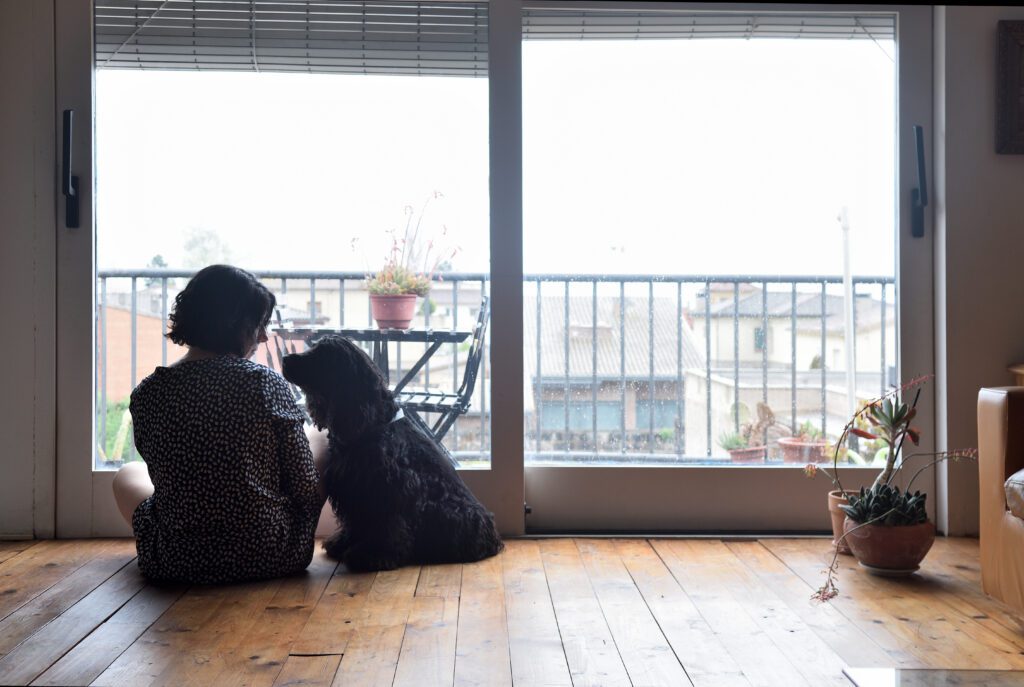 woman looking out with her dog