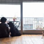woman looking out with her dog