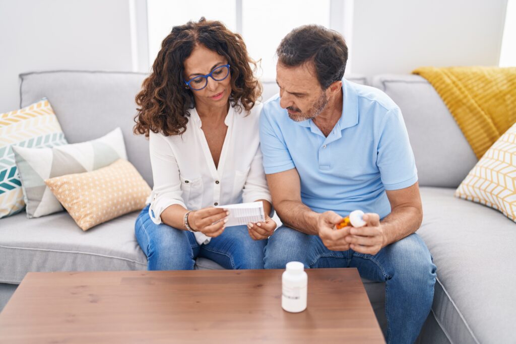 couple looking at pill bottle