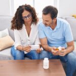couple looking at pill bottle
