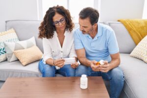 couple looking at pill bottle