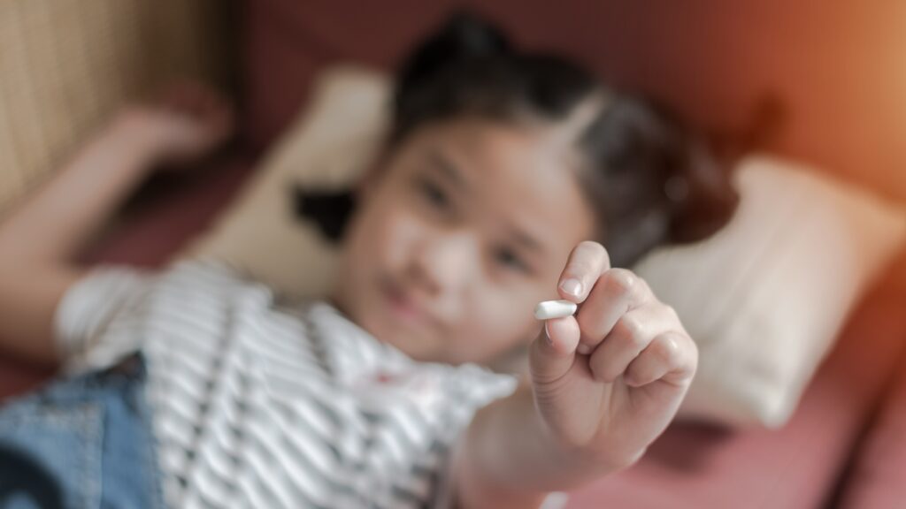 small child holding medication