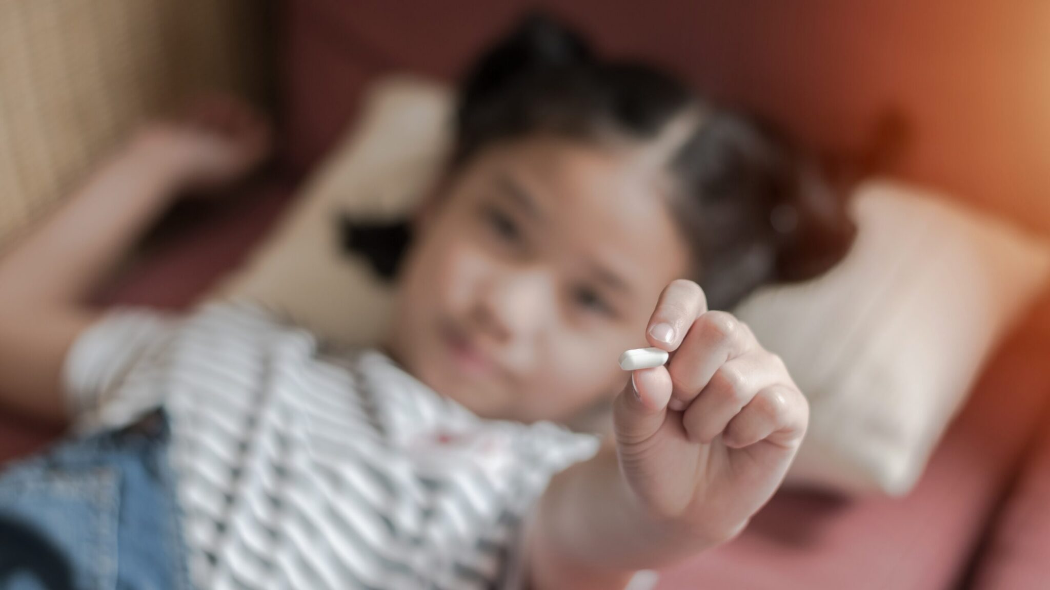 small child holding medication