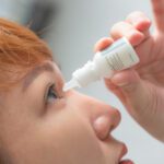woman putting in eye drops