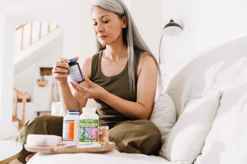 woman looking at supplement bottles