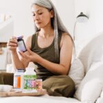 woman looking at supplement bottles