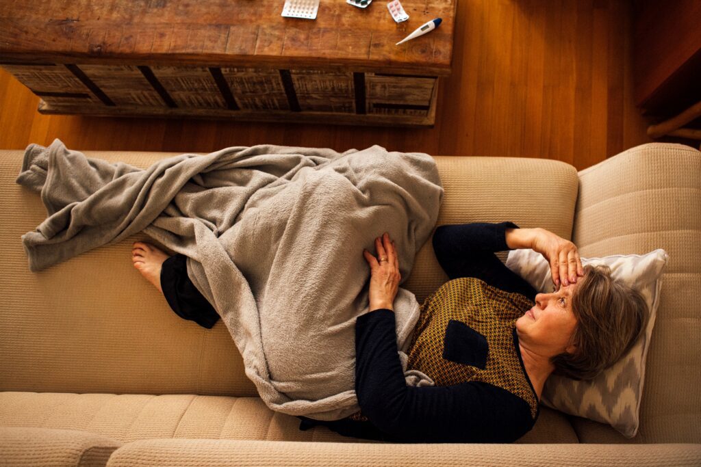 woman looking tired laying on couch