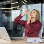 woman putting in eye drops