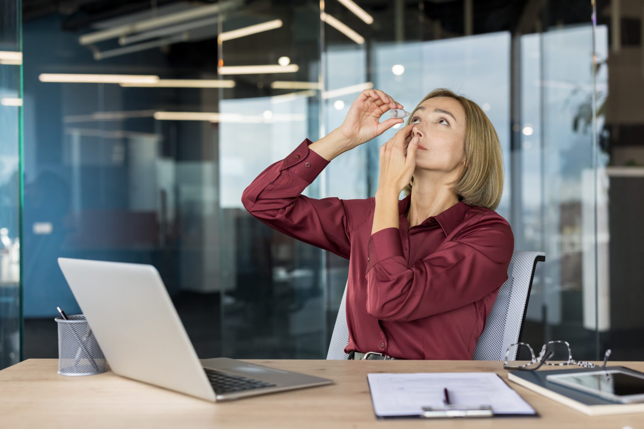 woman putting in eye drops