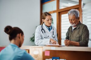 female doctor speaking to older male patient