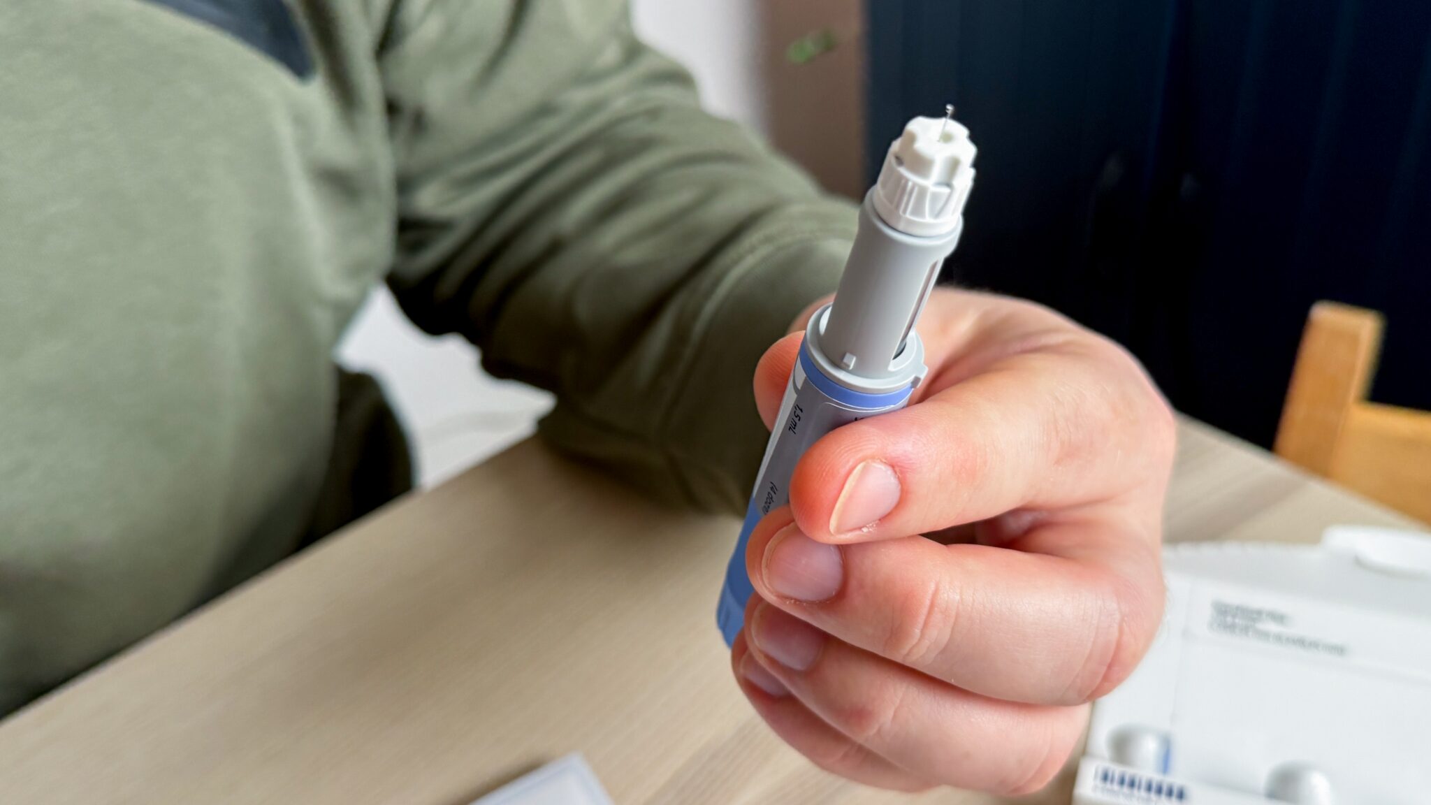 person holding ozempic pen