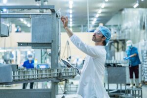 man doing quality control at a drug manufacturing lab